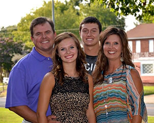 A picture of Dr. Unruhm wife and two children.